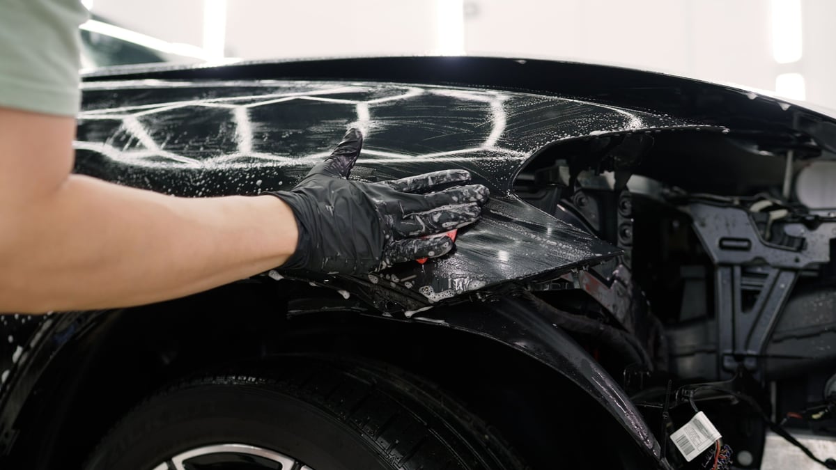 Professional car detailer cleaning a vehicle in Conroe
